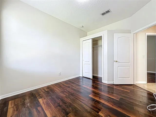 an empty room with wooden floor