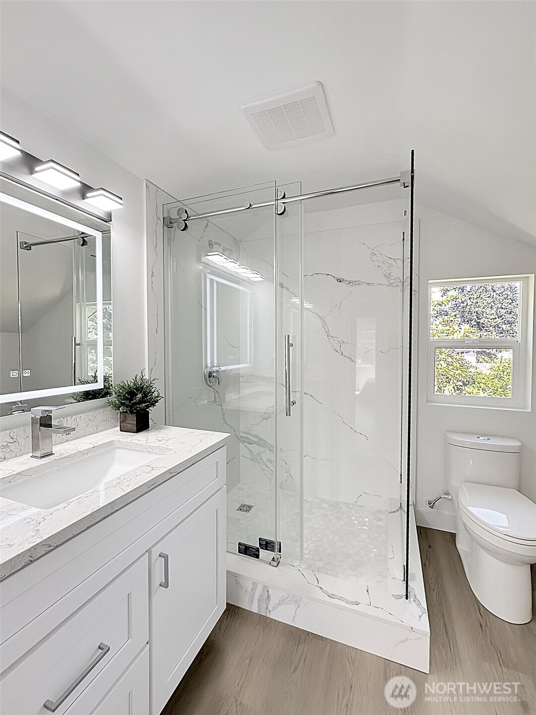 7403 Beverly Boulevard Everett, WA 98203 - Photo 12 of 19 a spacious bathroom with a shower sink vanity mirror and toilet