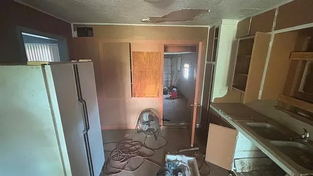 a bathroom with shower a mirror and a sink