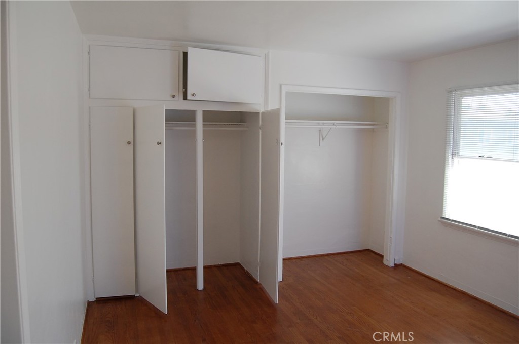 20 Roycroft Avenue Long Beach, CA 90803 - Photo 18 of 22 an empty room with wooden floor closet and windows