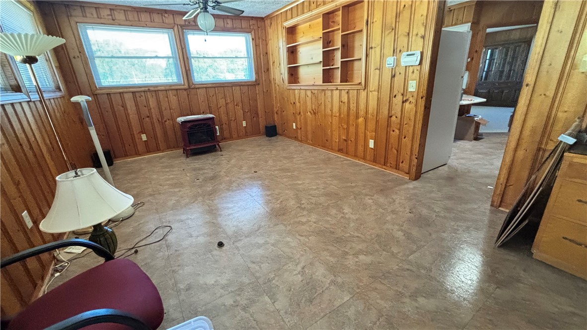 270 Flat Rock Road Liberty, SC 29657 - Photo 11 of 18 This versatile room features warm wood paneling and ample natural light, creating a welcoming atmosphere.