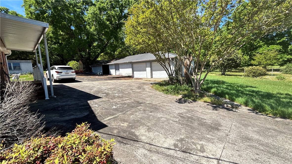 270 Flat Rock Road Liberty, SC 29657 - Photo 16 of 18 This property features a spacious paved driveway, offering ample parking and easy access to the garages.