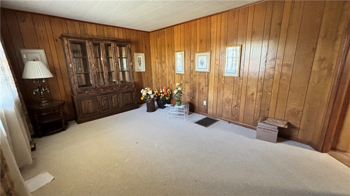 270 Flat Rock Road Liberty, SC 29657 - Photo 6 of 18 This inviting space features classic wood paneling and soft carpeting, creating a warm and comfortable atmosphere.