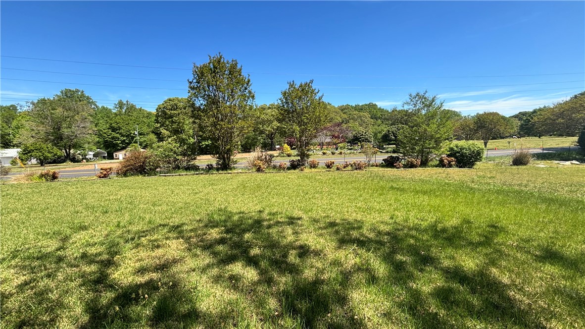 270 Flat Rock Road Liberty, SC 29657 - Photo 9 of 18 Expansive green lawn with mature trees and vibrant foliage offers endless outdoor possibilities.