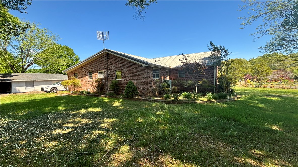 270 Flat Rock Road Liberty, SC 29657 - Photo 10 of 18 This classic brick residence boasts a spacious yard with mature trees, offering a serene outdoor retreat.