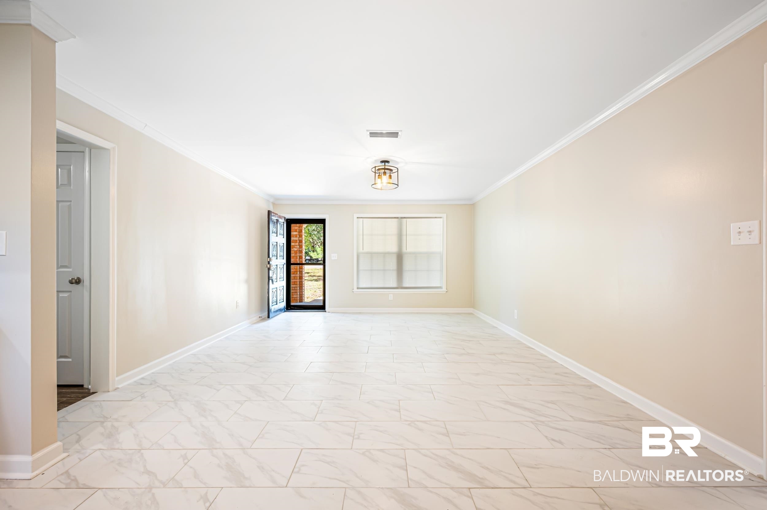 1605 Collier Avenue Bay Minette, AL 36507 - Photo 18 of 36 Spare room featuring light marble finish flooring and ornamental molding