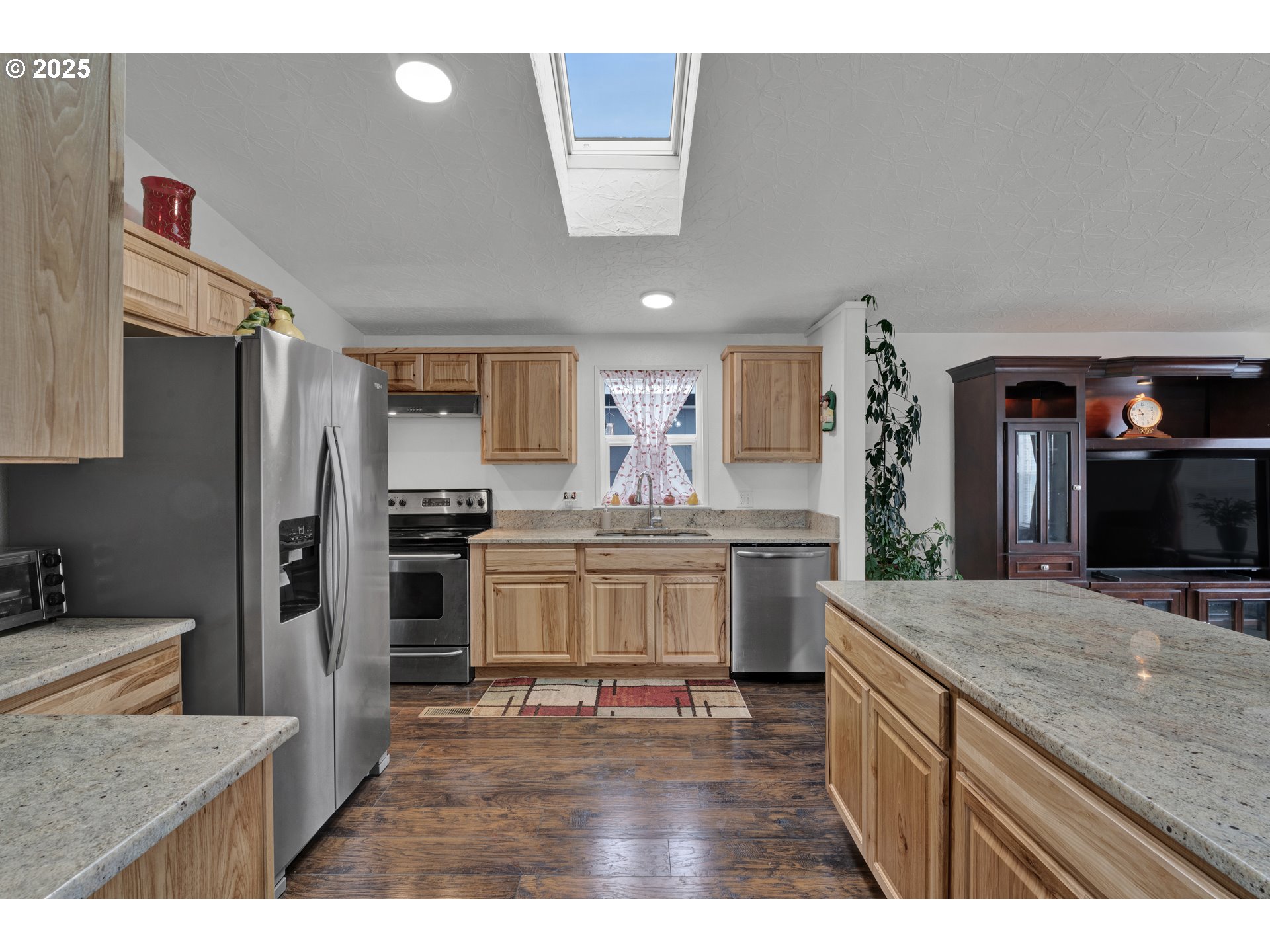 346 East 10th Place Junction City, OR 97448 - Photo 14 of 39 a kitchen with kitchen island granite countertop a sink stove and refrigerator