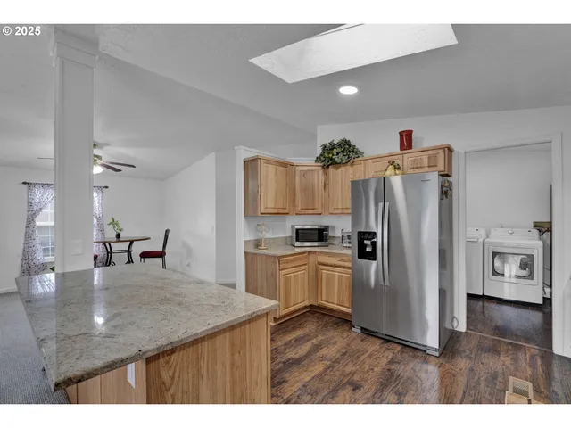 a kitchen with refrigerator cabinets and wooden floor
