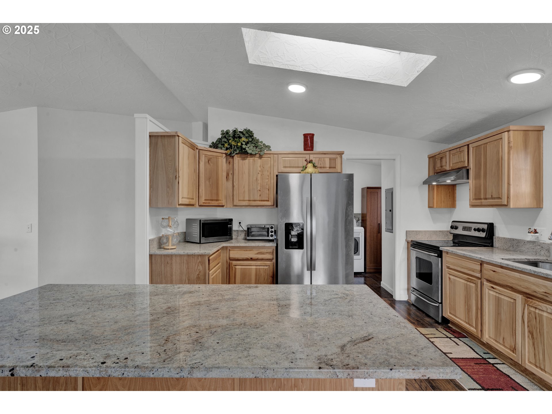 346 East 10th Place Junction City, OR 97448 - Photo 18 of 39 a kitchen with refrigerator and cabinets