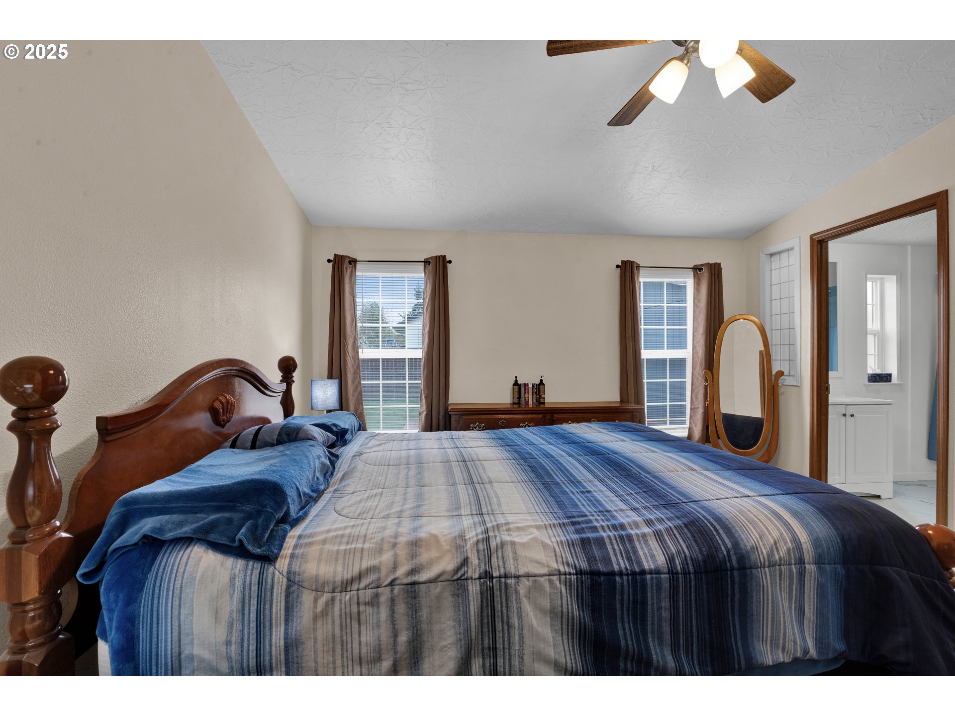 346 East 10th Place Junction City, OR 97448 - Photo 28 of 39 a bedroom with a large bed and a chandelier