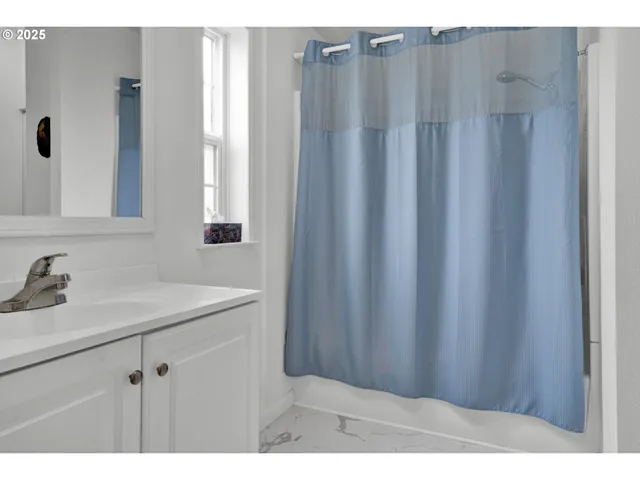 a bedroom with a bed and a mirror