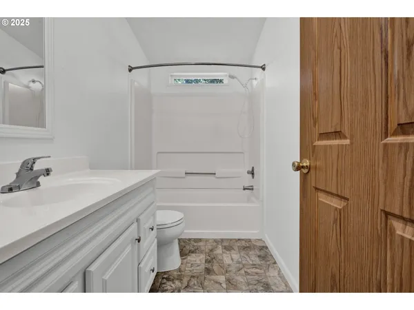 a bathroom with a sink a mirror and a vanity