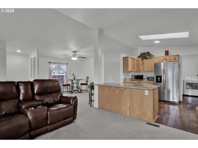 a living room with furniture and kitchen view