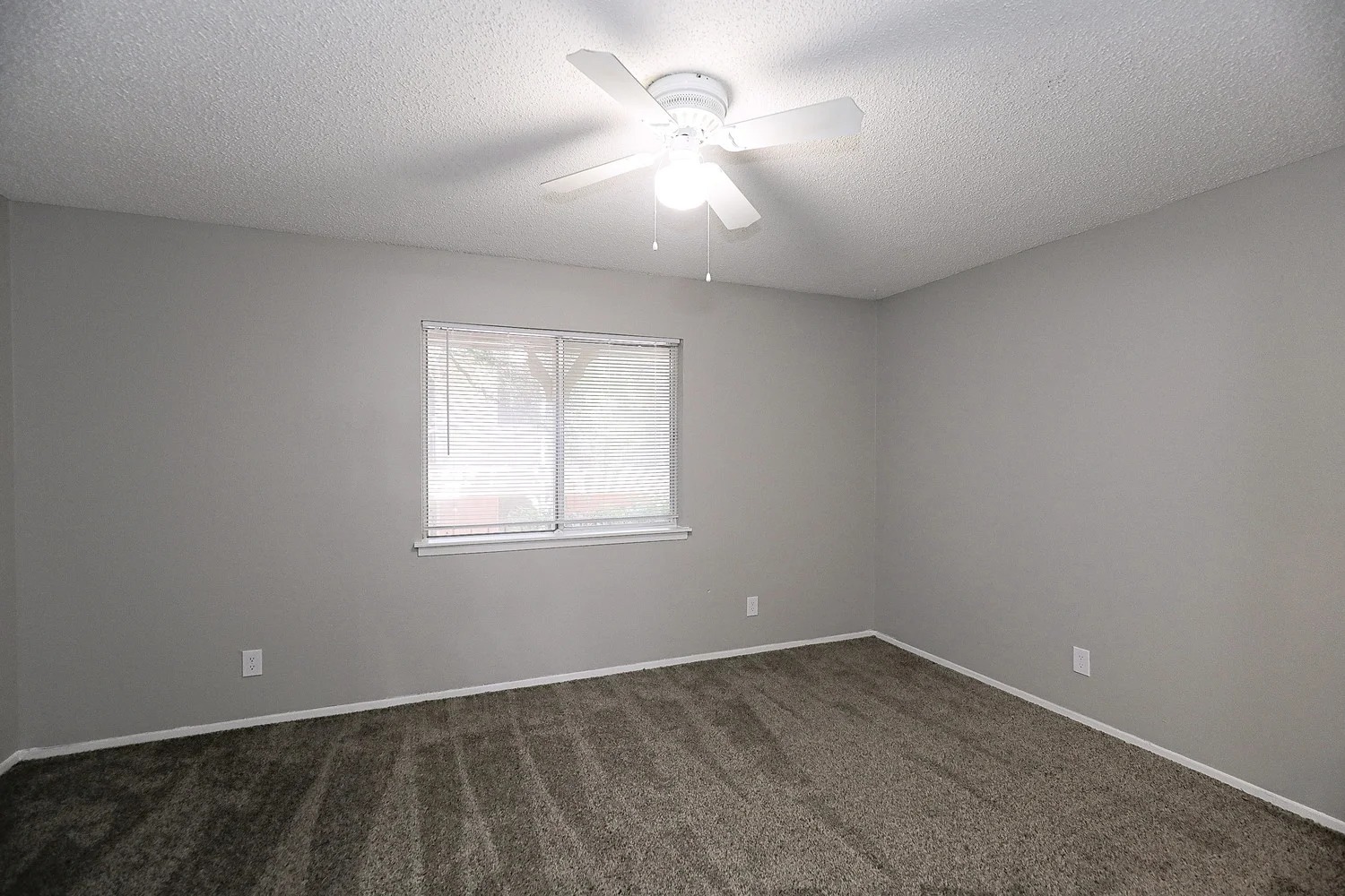 8100 North Mopac Expressway, Unit 17171 Austin, TX 78759 - Photo 18 of 22 Spare room featuring a textured ceiling, dark colored carpet, and ceiling fan