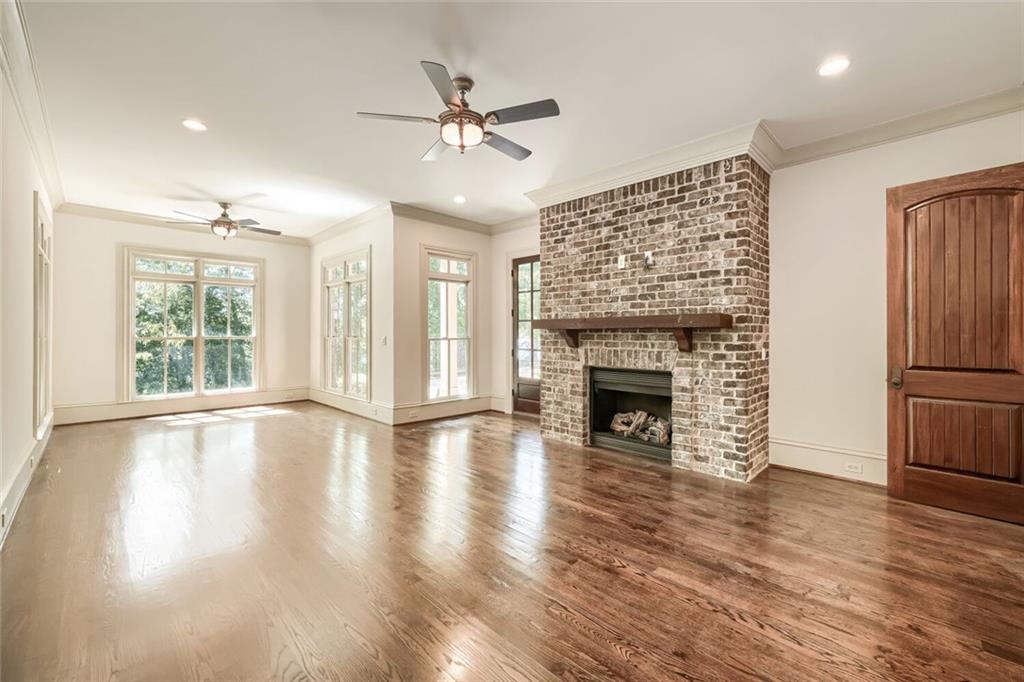 7965 Robin Road Cumming, GA 30041 - Photo 11 of 64 a view of an empty room with wooden floor fireplace and a window
