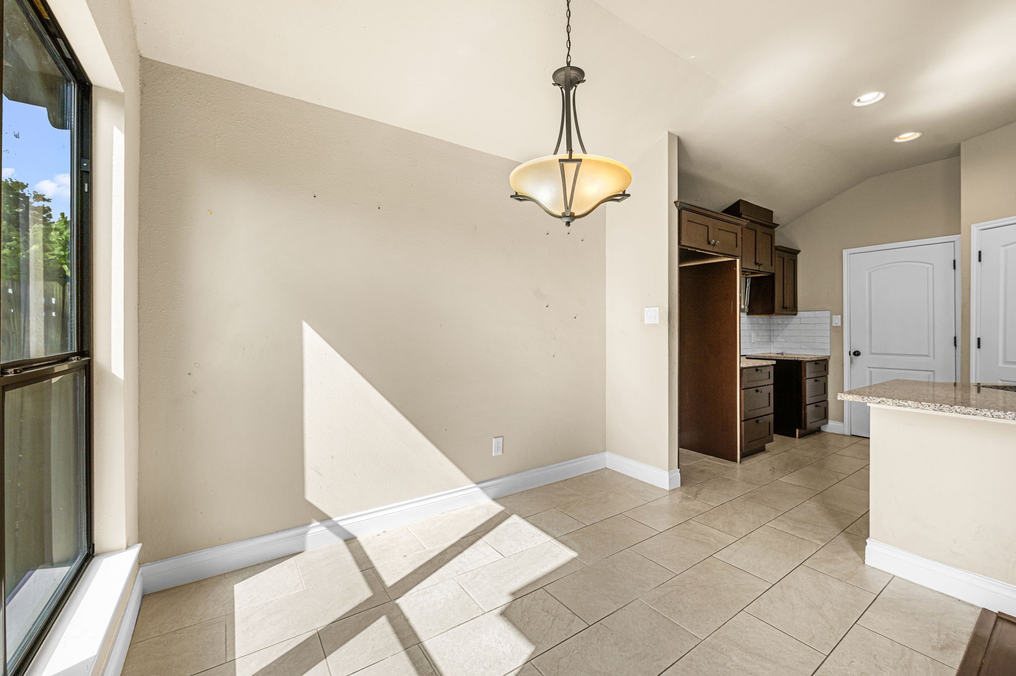 6838 Foster Street Houston, TX 77021 - Photo 8 of 24 Bright dining area with tile flooring, a decorative light fixture, and abundant natural light