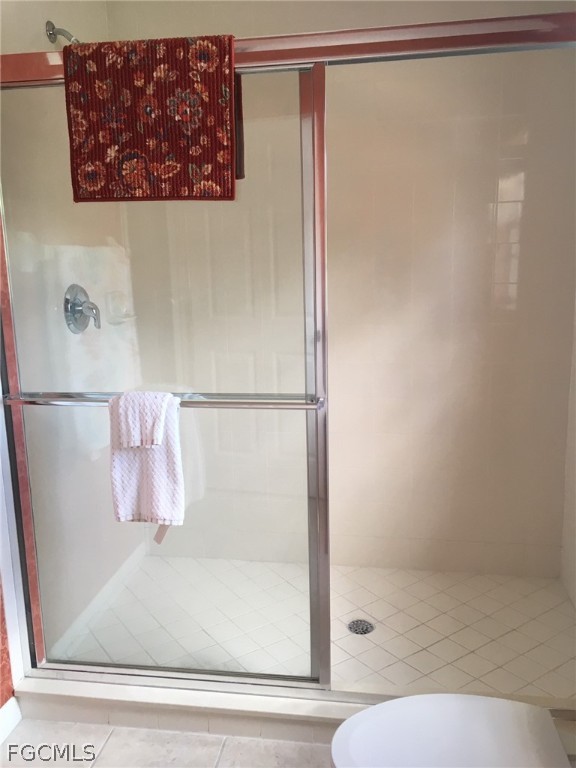 4500 Botanical Pl Circle, Unit 107 Naples, FL 34112 - Photo 21 of 39 a bathroom with a bathtub and a shower