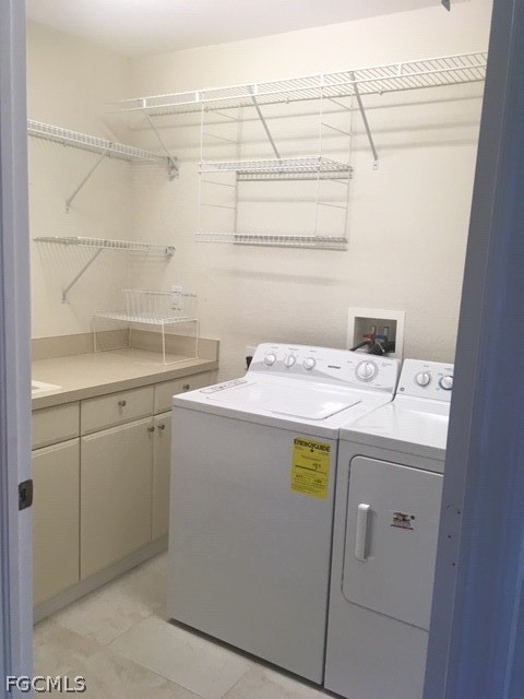 4500 Botanical Pl Circle, Unit 107 Naples, FL 34112 - Photo 25 of 39 a utility room with dryer and washer