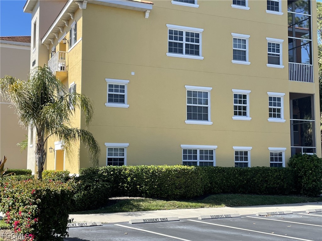 4500 Botanical Pl Circle, Unit 107 Naples, FL 34112 - Photo 3 of 39 a view of a building with a yard