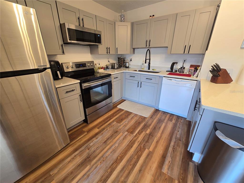 820 West 25th Street Sanford, FL 32771 - Photo 12 of 23 a kitchen with stainless steel appliances a refrigerator sink and microwave