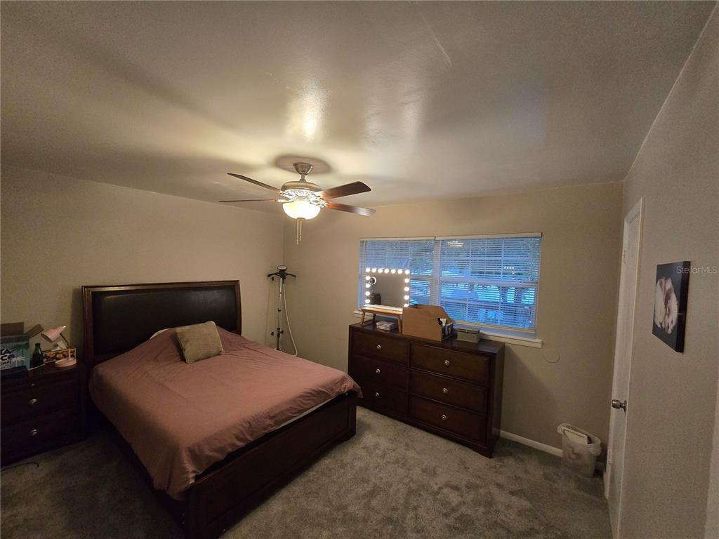 820 West 25th Street Sanford, FL 32771 - Photo 20 of 23 a bedroom with a bed and a chandelier