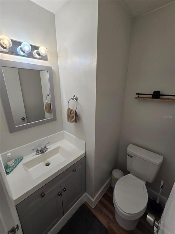 820 West 25th Street Sanford, FL 32771 - Photo 10 of 23 a bathroom with a toilet sink and mirror