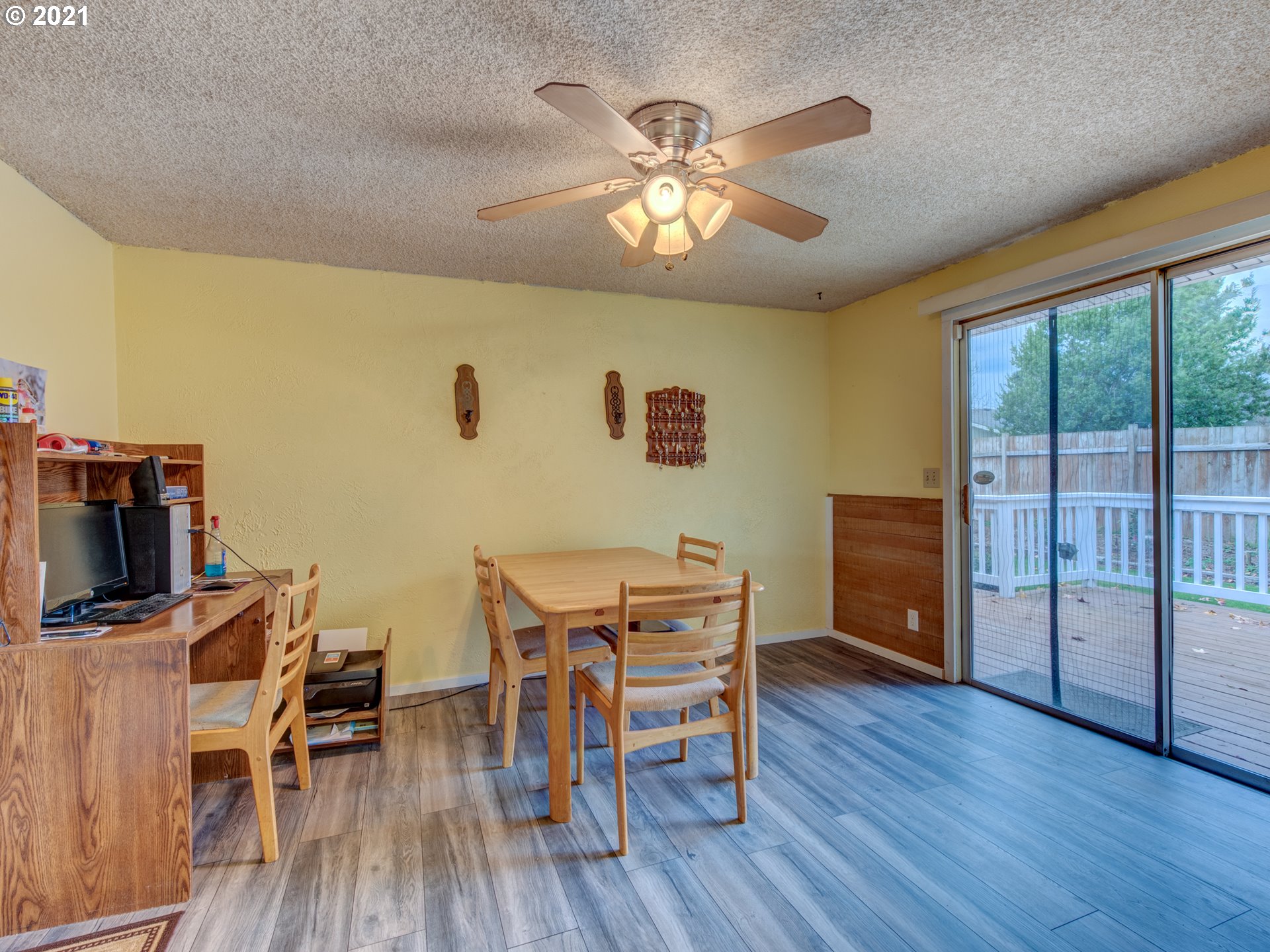 2277 11th Street Springfield, OR 97477 - Photo 11 of 24 a view of a dining room with furniture wooden floor and chandelier