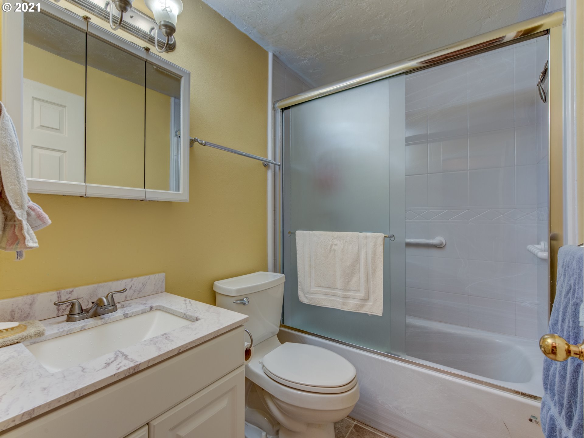 2277 11th Street Springfield, OR 97477 - Photo 15 of 24 a bathroom with a sink toilet vanity and shower