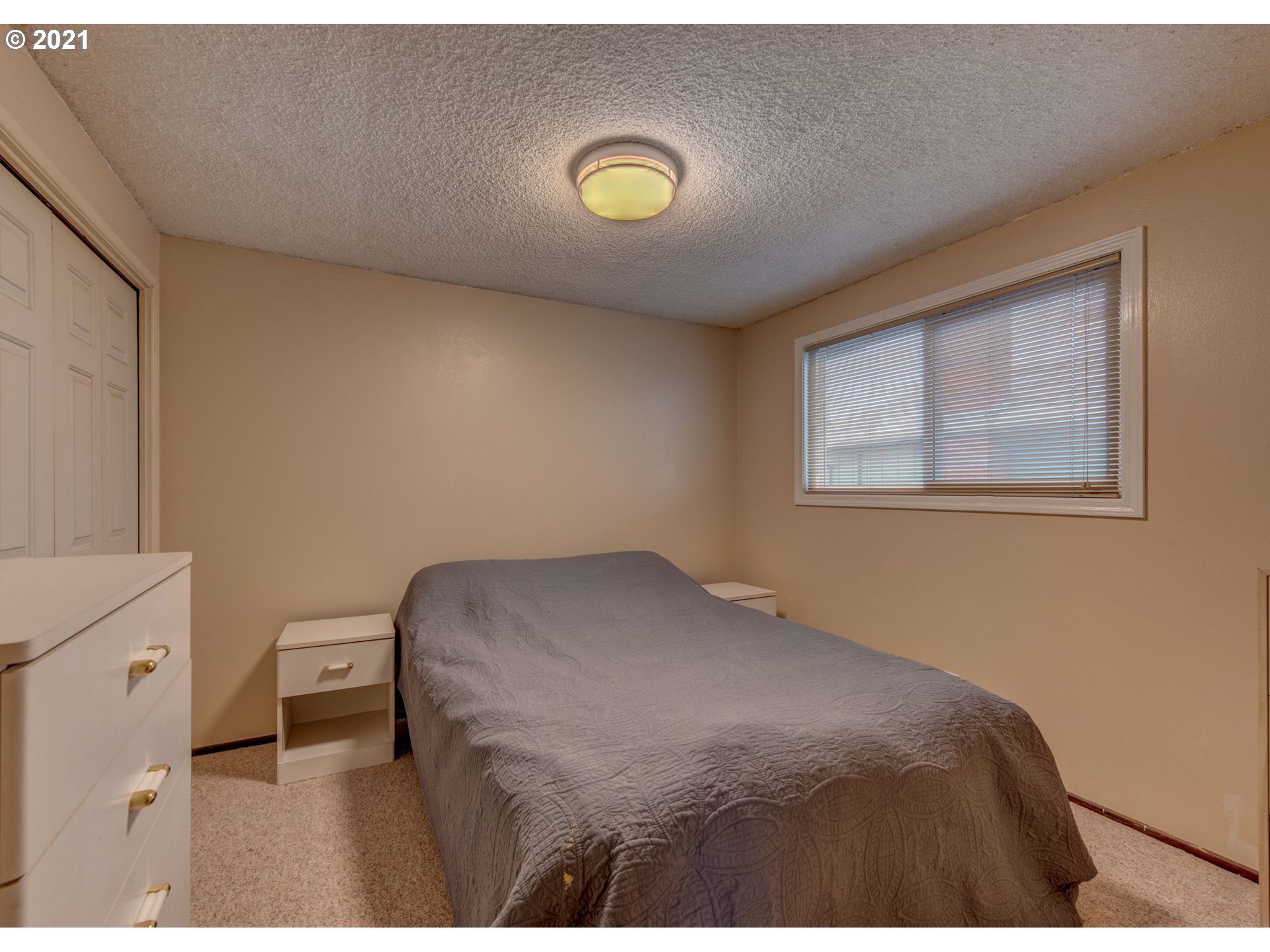 2277 11th Street Springfield, OR 97477 - Photo 17 of 24 a bedroom with a bed and a window