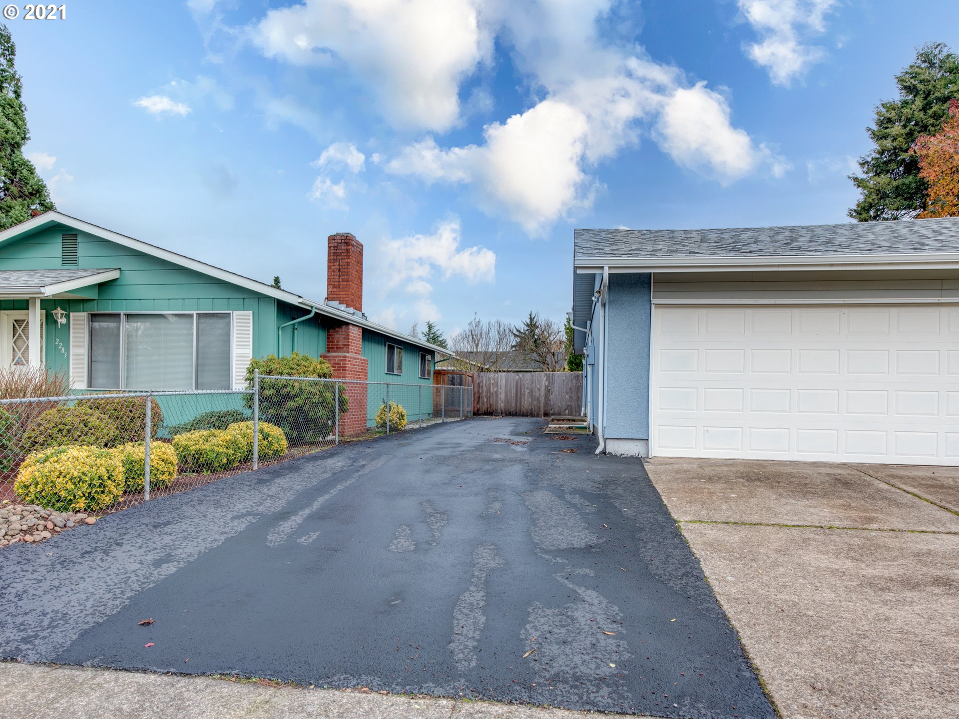 2277 11th Street Springfield, OR 97477 - Photo 23 of 24 a front view of a house with a yard and garage