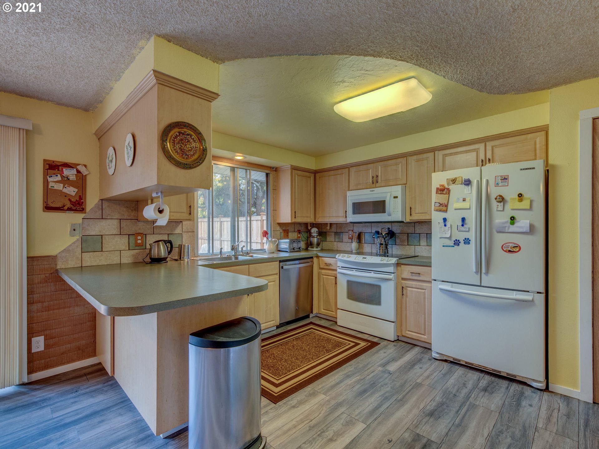 2277 11th Street Springfield, OR 97477 - Photo 8 of 24 a kitchen with cabinets and wooden floor