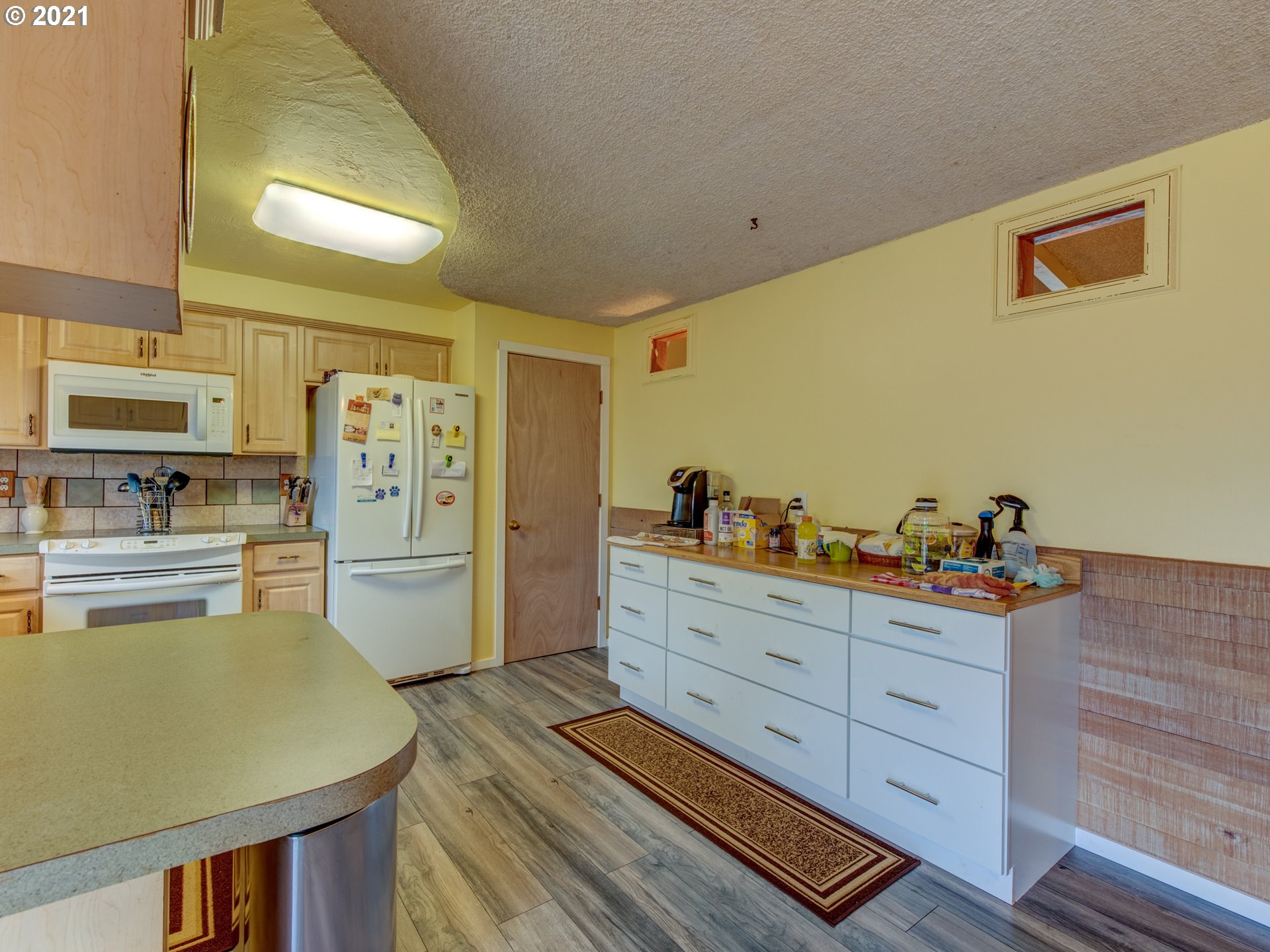 2277 11th Street Springfield, OR 97477 - Photo 9 of 24 a kitchen with stainless steel appliances wooden floor and a refrigerator