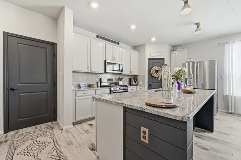 a living room with furniture and kitchen view