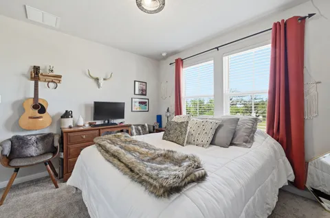 a bedroom with a bed and a flat screen tv