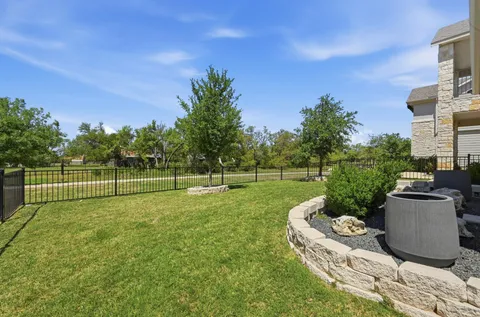 a garden with trees in the background