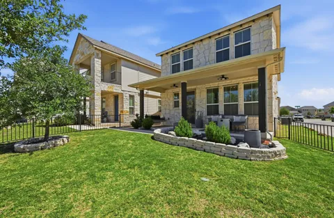 a front view of a house with a yard table and chairs