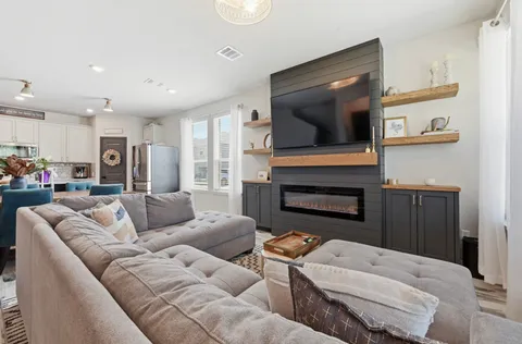 a living room with furniture and a flat screen tv