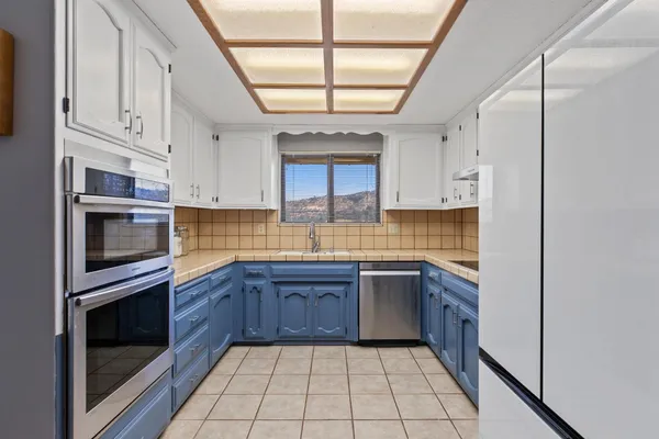 a kitchen with stainless steel appliances a stove sink and cabinets