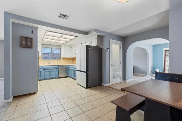 a kitchen with a refrigerator a sink and a stove top oven