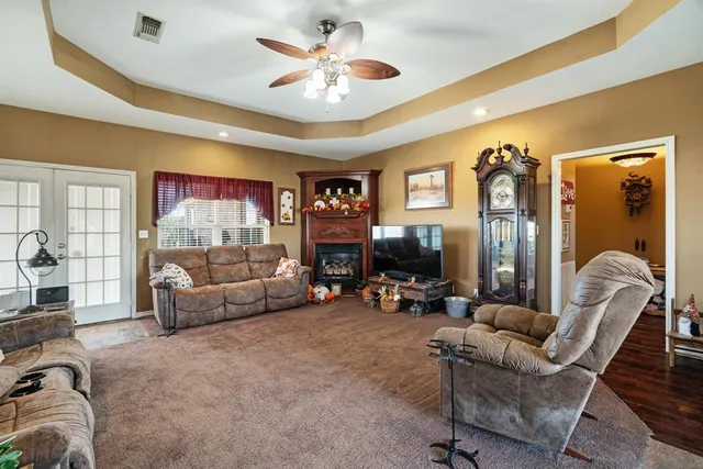 a kitchen with stainless steel appliances granite countertop a refrigerator a kitchen island a stove and a refrigerator