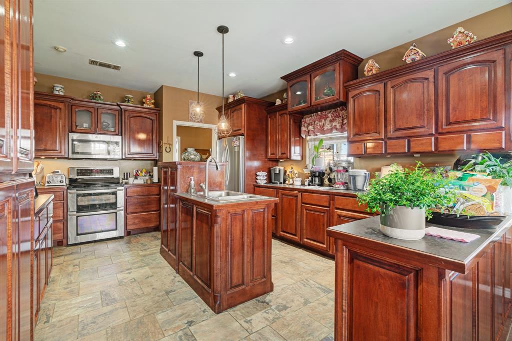 600 County Road Deport, TX 75435 - Photo 17 of 34 a kitchen with stainless steel appliances granite countertop a stove a sink and a refrigerator