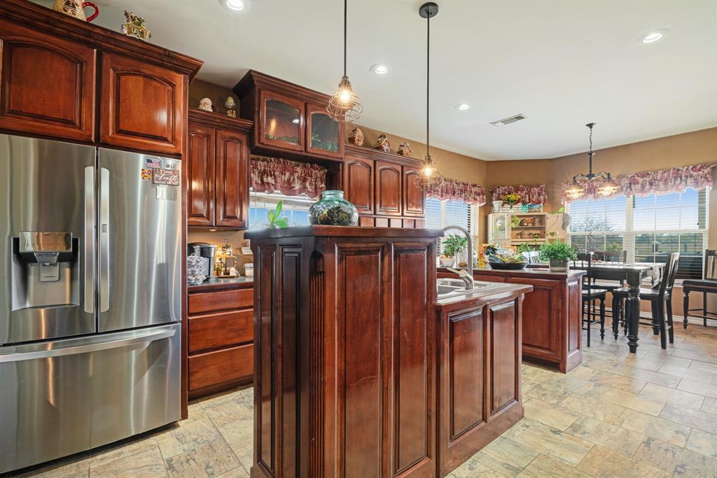 600 County Road Deport, TX 75435 - Photo 18 of 34 a kitchen with stainless steel appliances granite countertop a refrigerator a kitchen island a stove and a refrigerator
