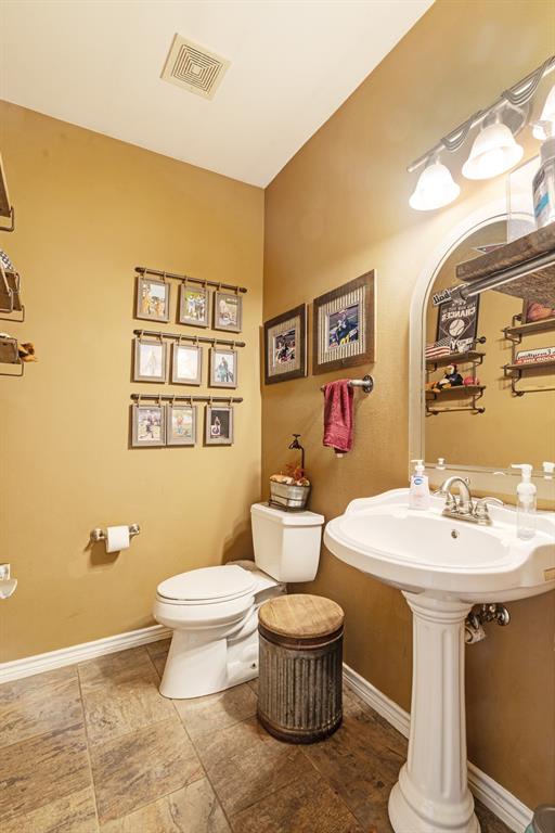 600 County Road Deport, TX 75435 - Photo 20 of 34 a bathroom with a toilet sink and mirror