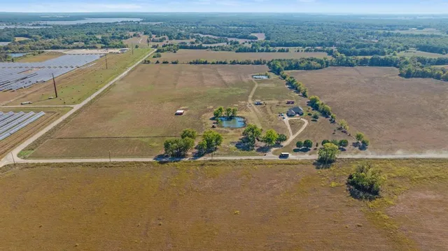 an aerial view of a house with a yard