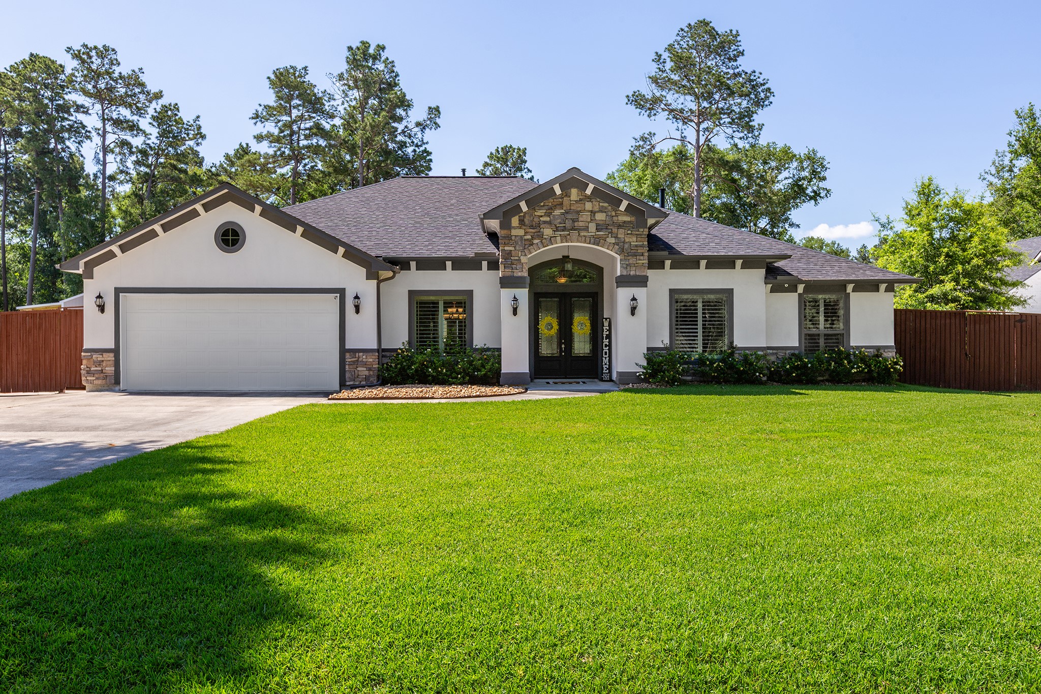 a front view of a house with a garden
