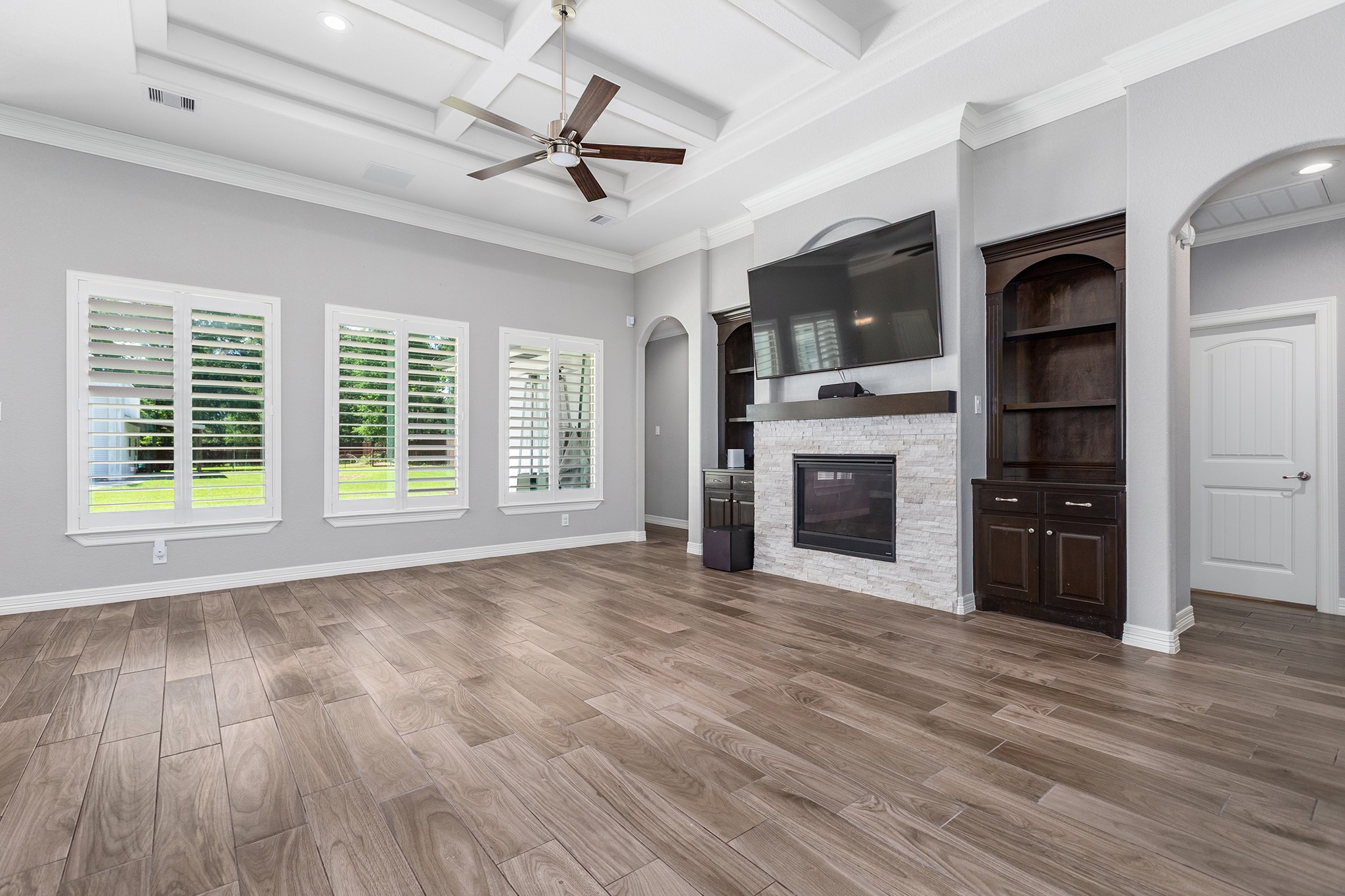 27600 Rio Blanco Drive Splendora, TX 77372 - Photo 11 of 49 a view of a kitchen with a stove a ceiling fan wooden floor and a ceiling fan