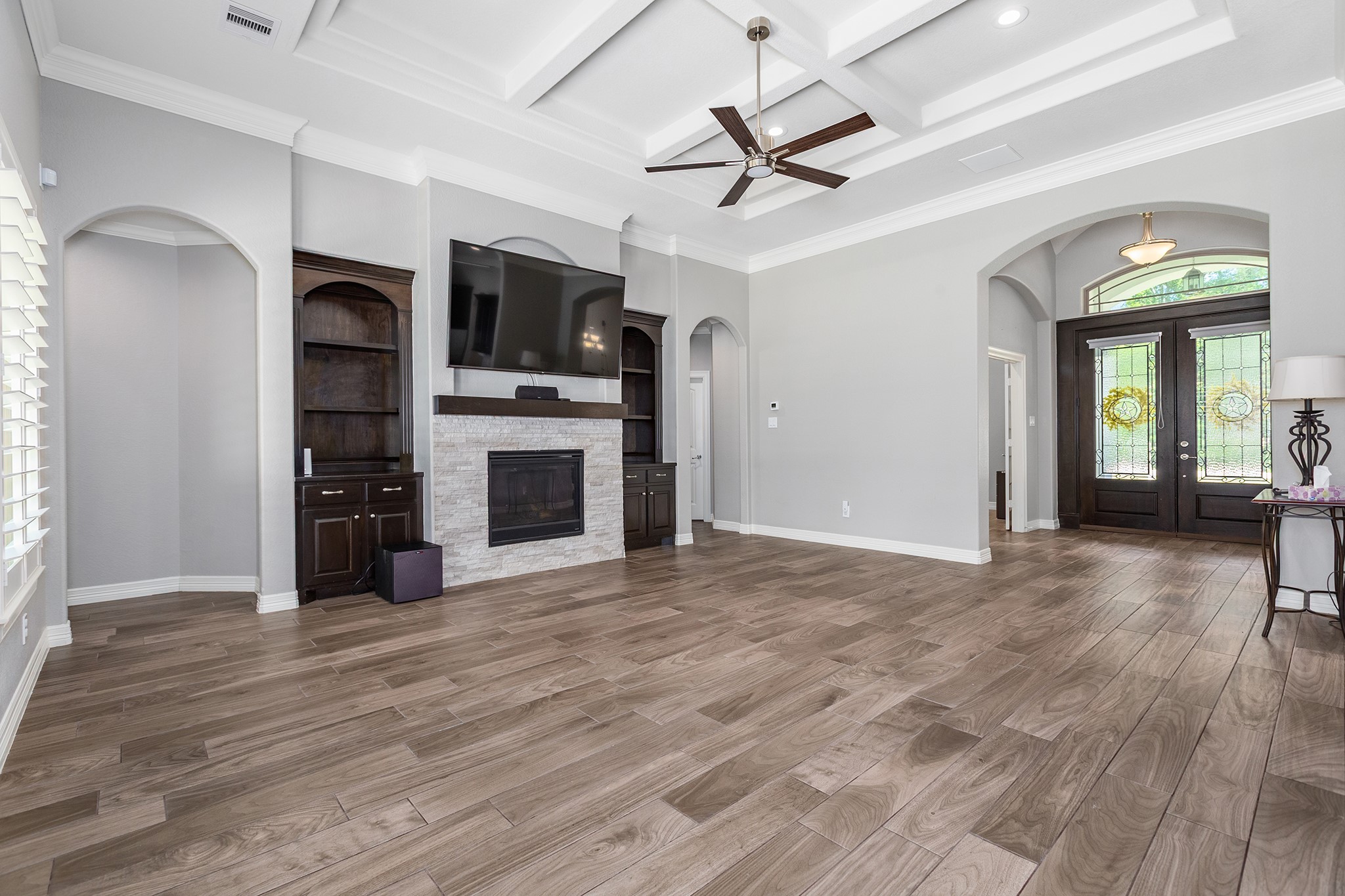27600 Rio Blanco Drive Splendora, TX 77372 - Photo 12 of 49 a view of a livingroom with a flat screen tv ceiling fan and hardwood floor