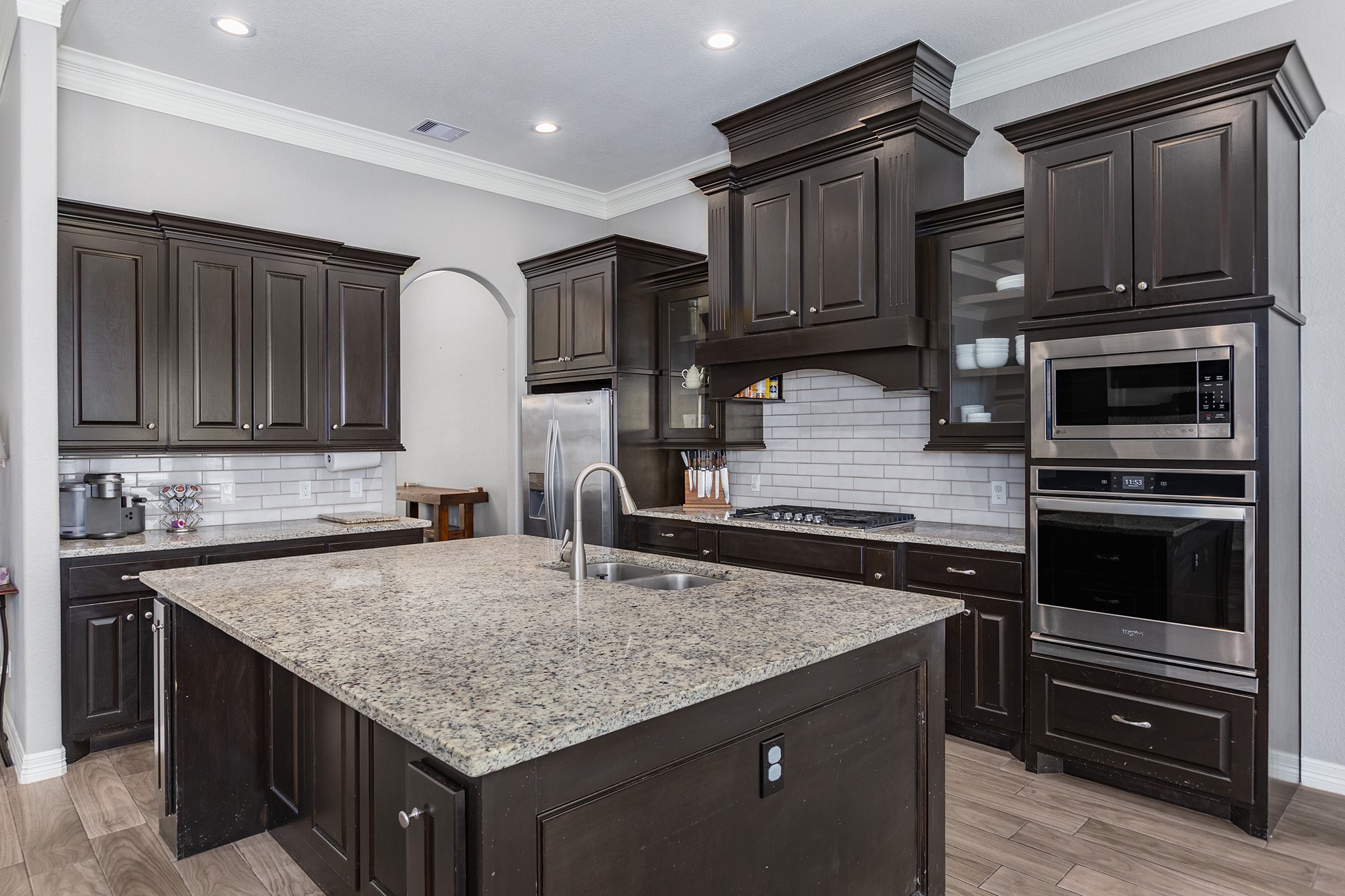 27600 Rio Blanco Drive Splendora, TX 77372 - Photo 16 of 49 a kitchen with kitchen island granite countertop a stove sink and cabinets
