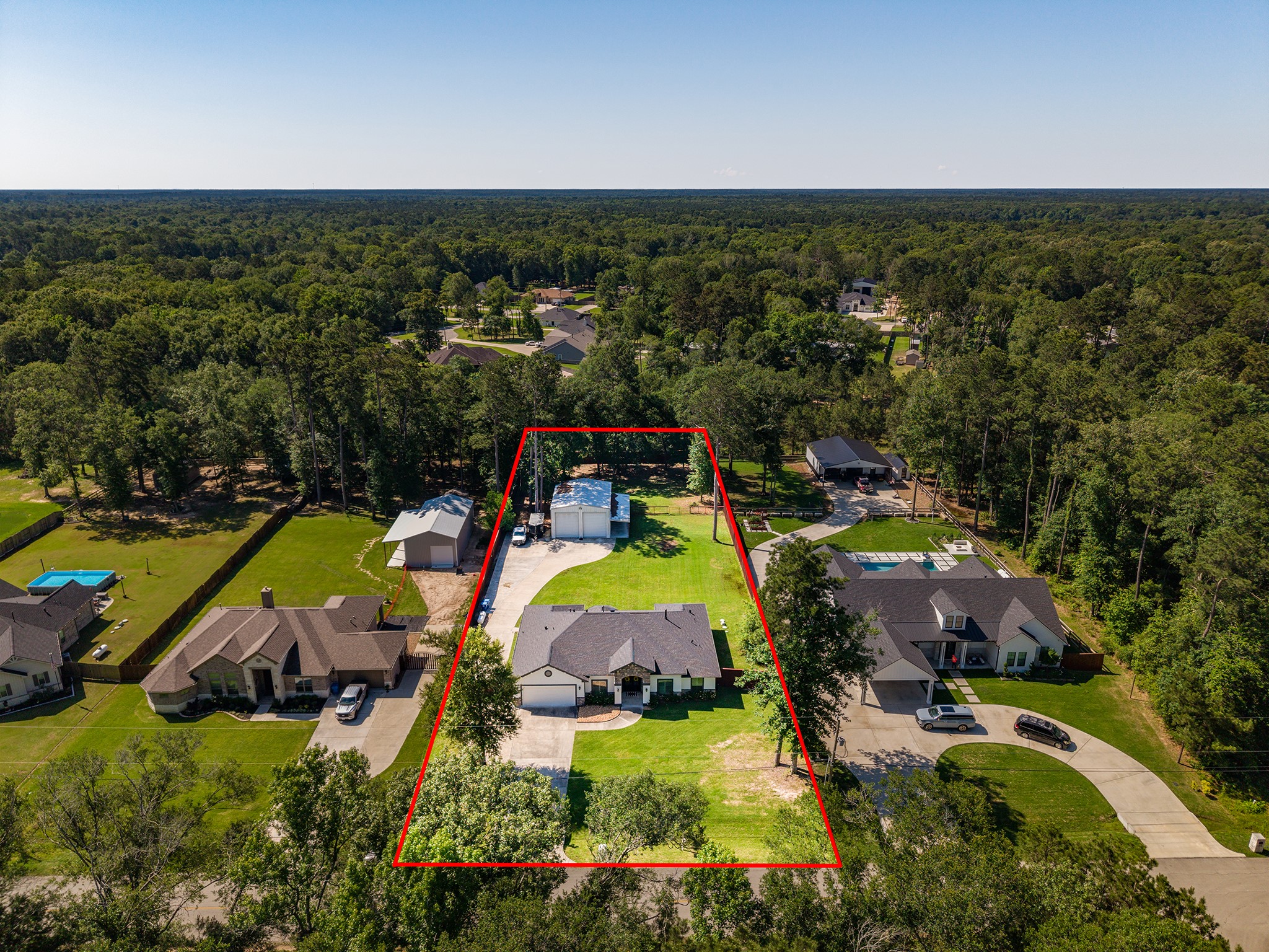27600 Rio Blanco Drive Splendora, TX 77372 - Photo 2 of 49 an aerial view of a house with a swimming pool yard and outdoor seating