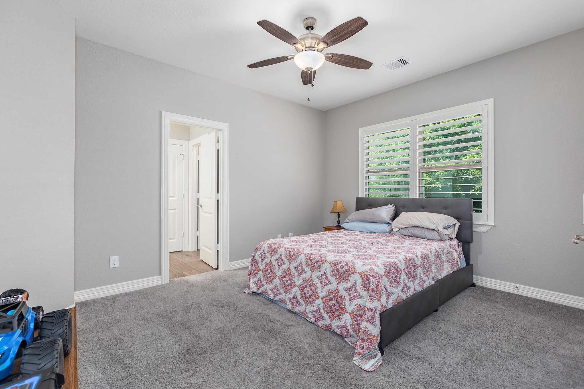 27600 Rio Blanco Drive Splendora, TX 77372 - Photo 28 of 49 a bedroom with a bed and a ceiling fan